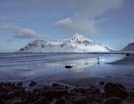 Surfer Skagsanden Beach winter Lofoten Islands Norway, landscape photography by Peter Mikolas 
